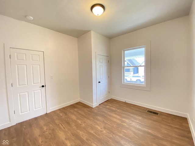 1518 Lawton Ave, Indianapolis, IN 46203 - unfurnished bedroom featuring wood finished floors