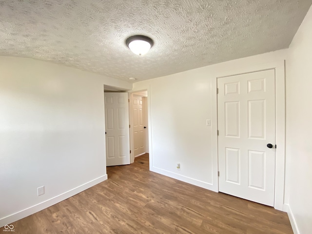 1518 Lawton Ave, Indianapolis, IN 46203 - unfurnished bedroom featuring wood finished floors and a textured ceiling