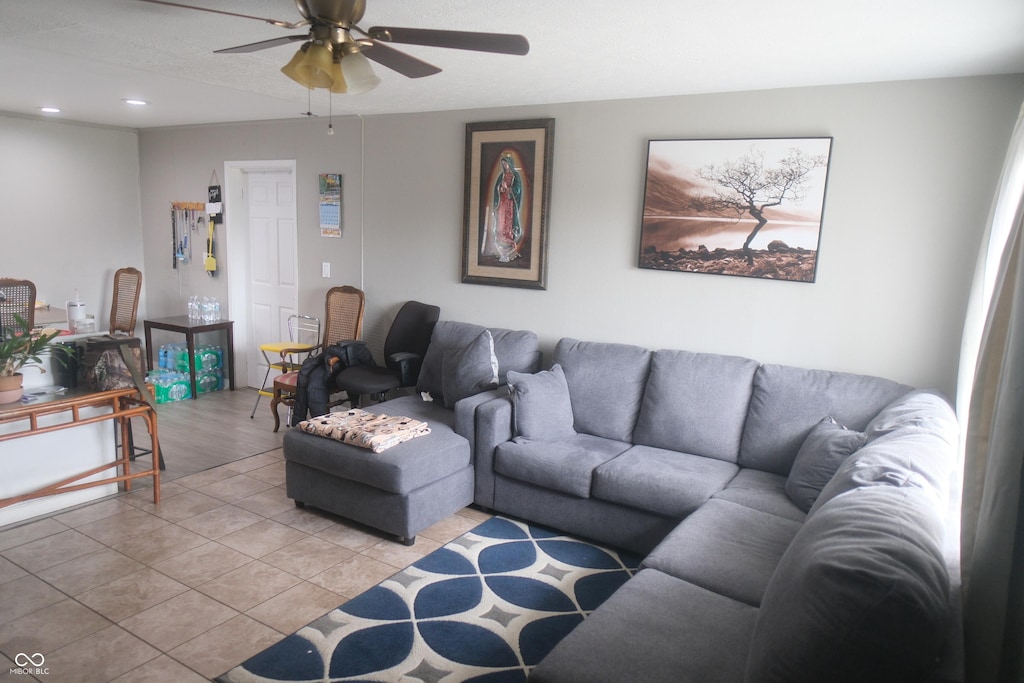 living area with light tile patterned floors, ceiling fan, and recessed lighting
