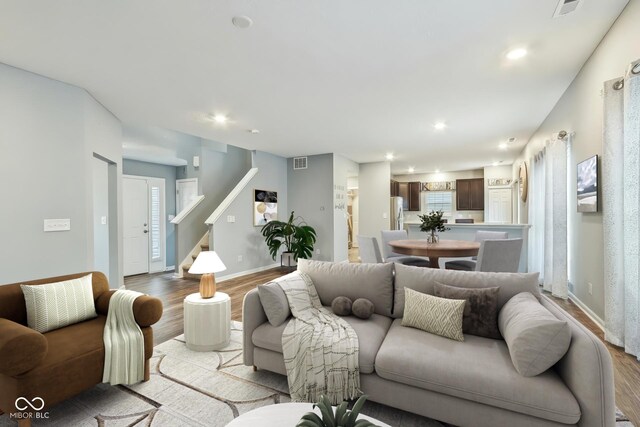5150 Bramwell Ln, Whitestown, IN 46075 - living room featuring light wood-style flooring, baseboards, recessed lighting, and stairs