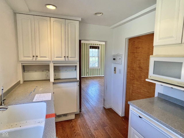 7180 N State Road 42, Eminence, IN 46125 - kitchen featuring baseboards, a sink, white microwave, white cabinetry, and dark wood-type flooring