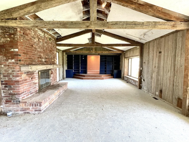7180 N State Road 42, Eminence, IN 46125 - unfurnished living room with wood walls, vaulted ceiling with beams, and a brick fireplace