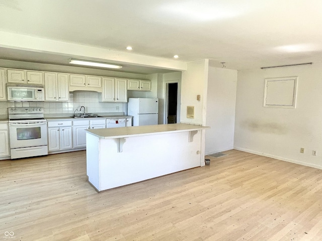 7180 N State Road 42, Eminence, IN 46125 - kitchen with tasteful backsplash, white appliances, light wood-style floors, and a sink