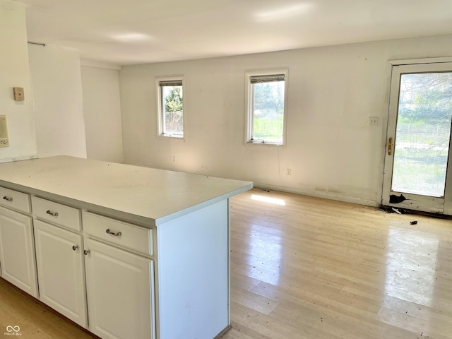 7180 N State Road 42, Eminence, IN 46125 - kitchen featuring a peninsula, light wood-style flooring, white cabinetry, and light countertops