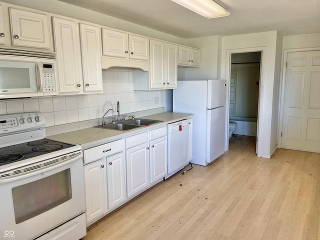7180 N State Road 42, Eminence, IN 46125 - kitchen featuring tasteful backsplash, white appliances, white cabinetry, light wood finished floors, and a sink