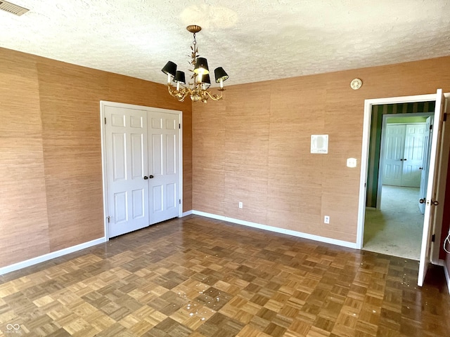 7180 N State Road 42, Eminence, IN 46125 - unfurnished bedroom featuring visible vents, baseboards, a notable chandelier, and a textured ceiling