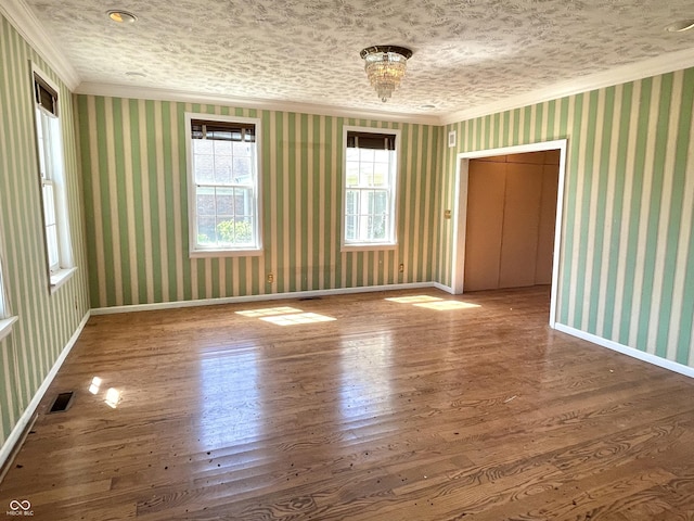 7180 N State Road 42, Eminence, IN 46125 - unfurnished room featuring visible vents, baseboards, crown molding, wood finished floors, and wallpapered walls