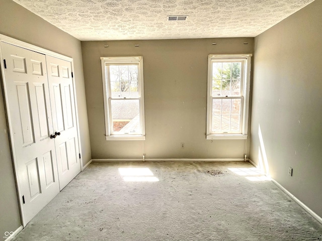 7180 N State Road 42, Eminence, IN 46125 - unfurnished bedroom featuring a textured ceiling, a closet, baseboards, and visible vents