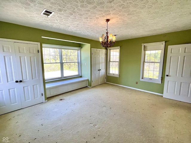 7180 N State Road 42, Eminence, IN 46125 - interior space with two closets, visible vents, carpet floors, baseboards, and a notable chandelier