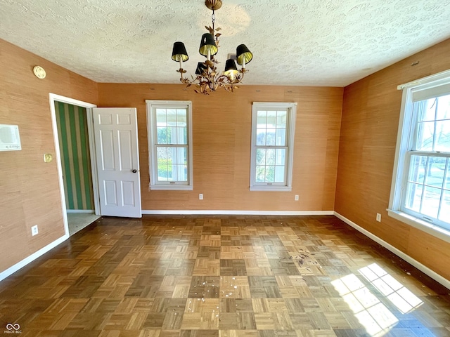 7180 N State Road 42, Eminence, IN 46125 - interior space with a textured ceiling, a healthy amount of sunlight, an inviting chandelier, and baseboards