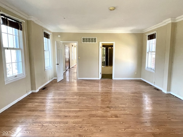 7180 N State Road 42, Eminence, IN 46125 - empty room featuring crown molding, visible vents, plenty of natural light, and wood finished floors