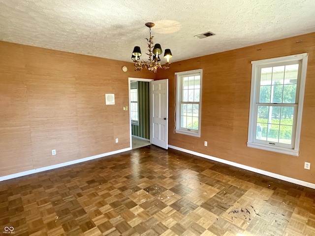 7180 N State Road 42, Eminence, IN 46125 - spare room with a chandelier, a textured ceiling, visible vents, and a wealth of natural light