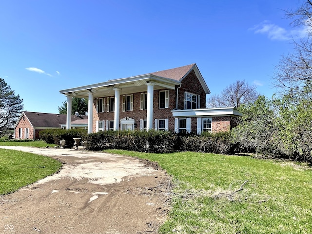 7180 N State Road 42, Eminence, IN 46125 - greek revival house with brick siding and a front lawn
