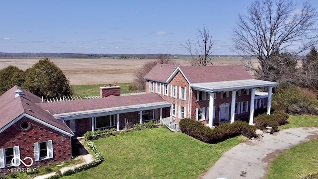 7180 N State Road 42, Eminence, IN 46125 - view of front of home featuring a rural view, brick siding, a chimney, and a front lawn