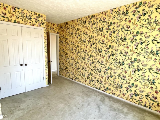 7180 N State Road 42, Eminence, IN 46125 - unfurnished bedroom with a closet, a textured ceiling, and wallpapered walls