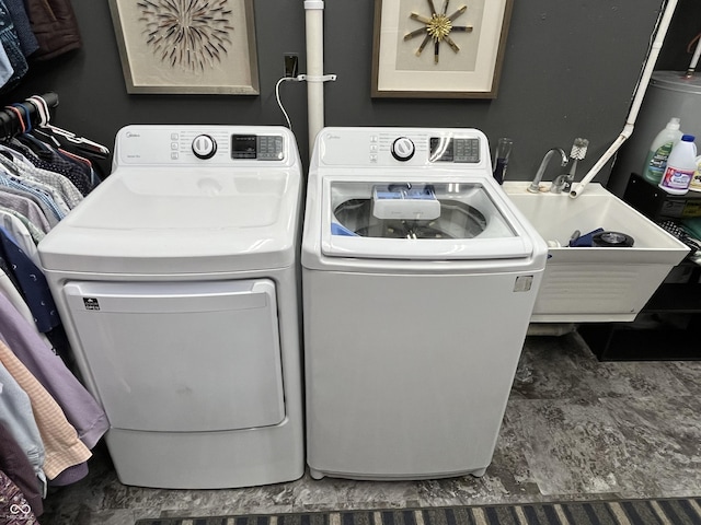laundry area with washing machine and dryer, laundry area, and a sink