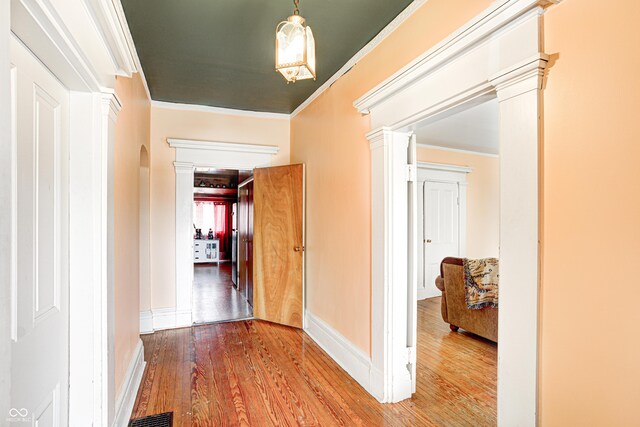 110 E Hendricks St, Shelbyville, IN 46176 - corridor with baseboards, crown molding, wood finished floors, and ornate columns