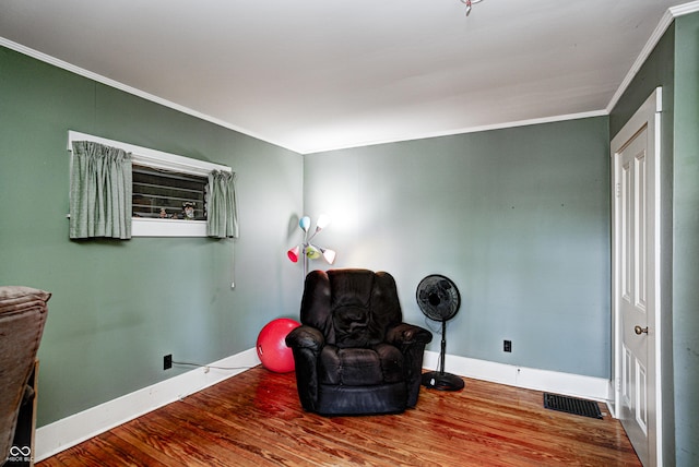 110 E Hendricks St, Shelbyville, IN 46176 - sitting room with visible vents, crown molding, baseboards, and wood finished floors