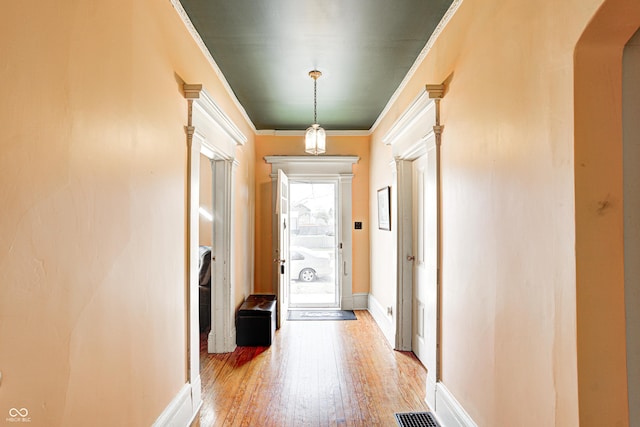 110 E Hendricks St, Shelbyville, IN 46176 - hall with arched walkways, baseboards, light wood-style floors, and crown molding