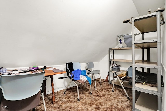 carpeted home office featuring vaulted ceiling