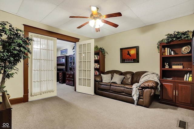 carpeted living room featuring visible vents, ceiling fan, french doors, and a paneled ceiling