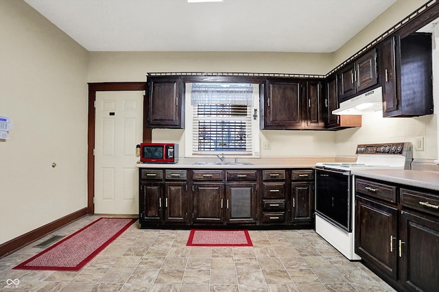 kitchen with extractor fan, light countertops, a sink, and range with electric cooktop