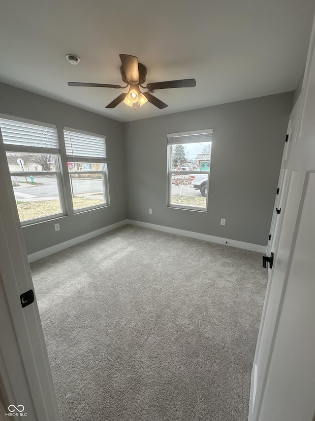 1746 Lambert St, Indianapolis, IN 46221 - unfurnished bedroom with baseboards, multiple windows, and carpet
