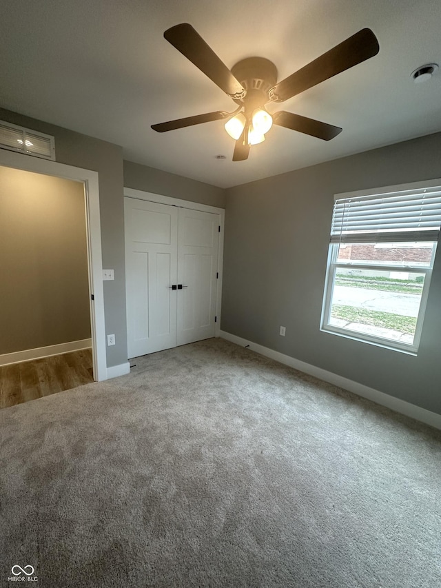 1746 Lambert St, Indianapolis, IN 46221 - unfurnished bedroom with a closet, carpet flooring, visible vents, baseboards, and ceiling fan