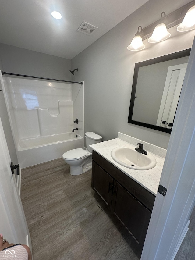 1746 Lambert St, Indianapolis, IN 46221 - full bath with visible vents, wood finished floors, toilet, vanity, and shower / bathing tub combination