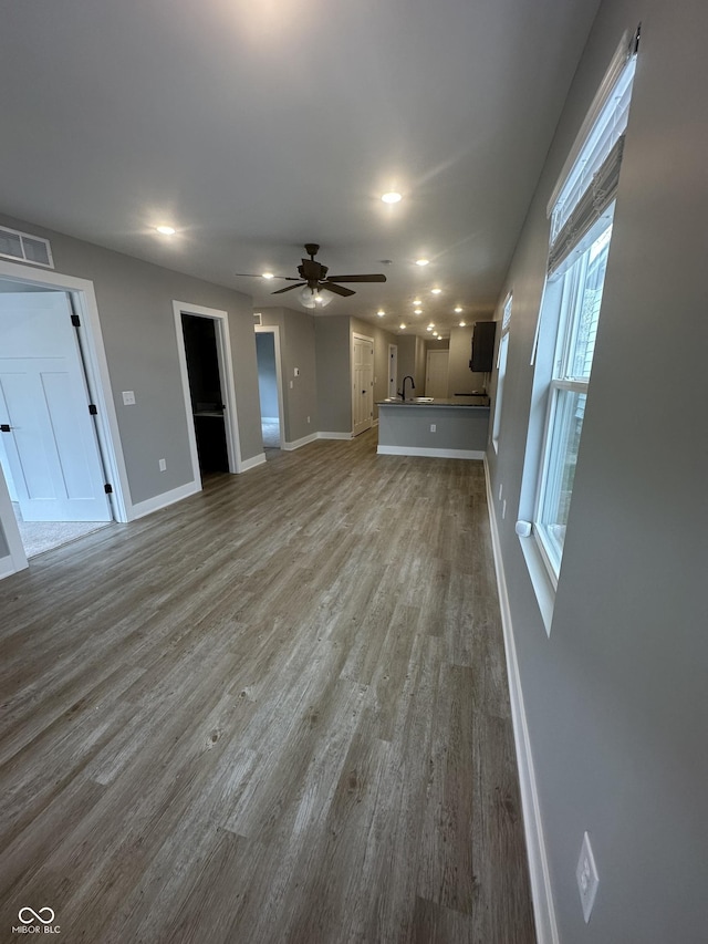 1746 Lambert St, Indianapolis, IN 46221 - unfurnished living room with visible vents, baseboards, ceiling fan, wood finished floors, and recessed lighting