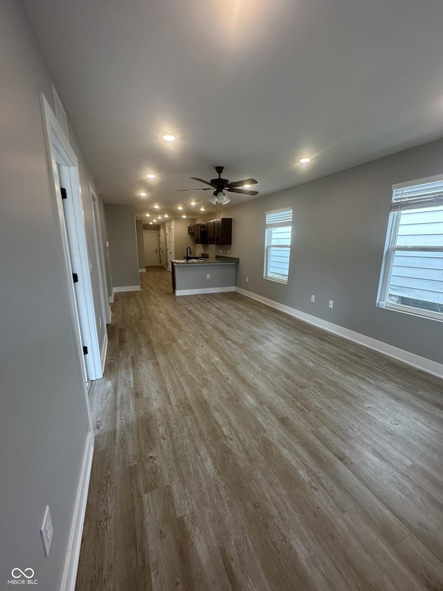 1746 Lambert St, Indianapolis, IN 46221 - unfurnished living room with a ceiling fan, baseboards, and wood finished floors