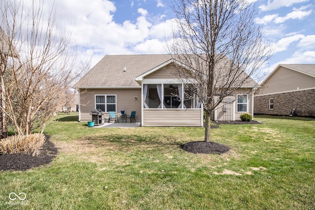 rear view of house featuring a sunroom, a patio, ceiling fan, roof with shingles, and a yard