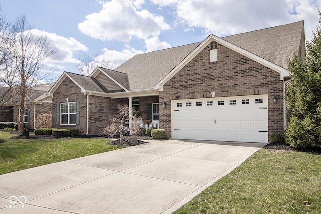 ranch-style home with brick siding, driveway, an attached garage, and a front lawn