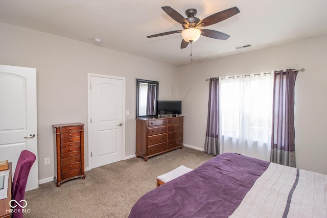 carpeted bedroom with baseboards, visible vents, and a ceiling fan