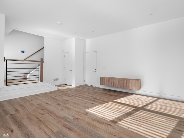 2578 Filson St, Carmel, IN 46032 - unfurnished living room with baseboards, wood finished floors, and visible vents