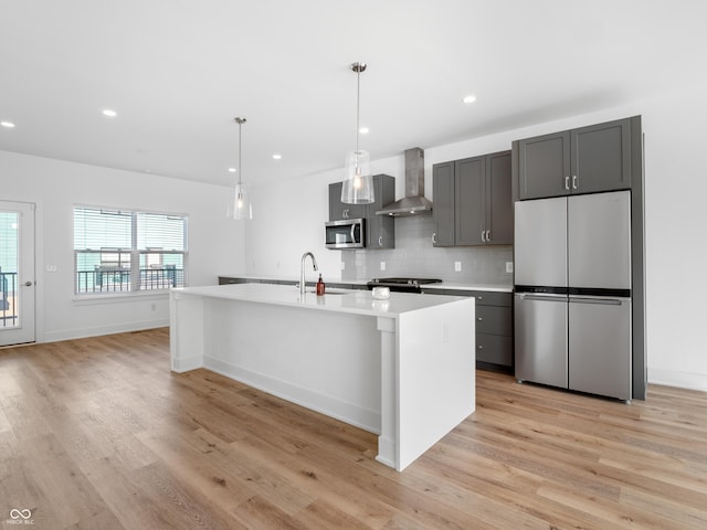2578 Filson St, Carmel, IN 46032 - kitchen featuring light countertops, appliances with stainless steel finishes, wall chimney exhaust hood, and light wood-style floors