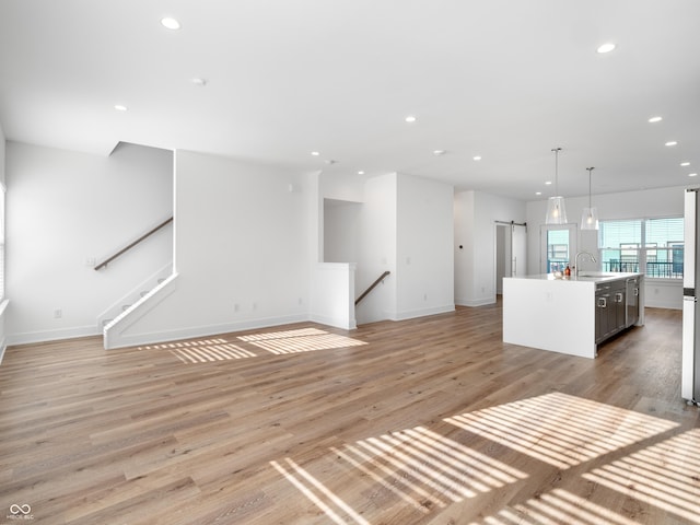 2578 Filson St, Carmel, IN 46032 - unfurnished living room with recessed lighting, a sink, light wood-style floors, and baseboards