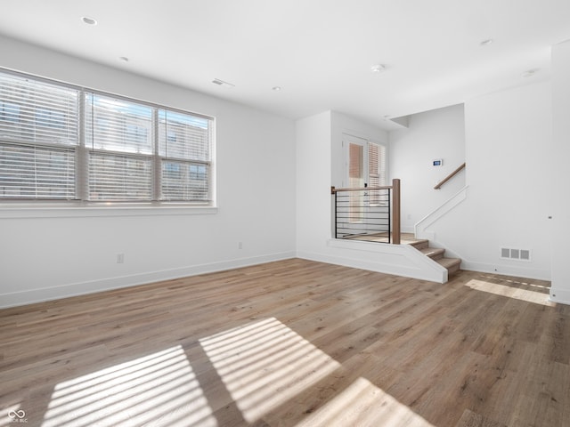 2578 Filson St, Carmel, IN 46032 - unfurnished living room featuring baseboards, visible vents, a wealth of natural light, and light wood-style floors