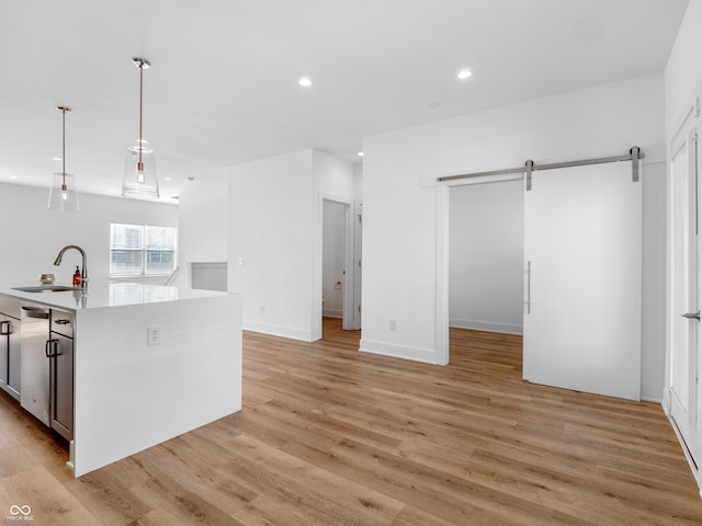 2578 Filson St, Carmel, IN 46032 - kitchen featuring a barn door, a sink, light wood-style floors, light countertops, and recessed lighting