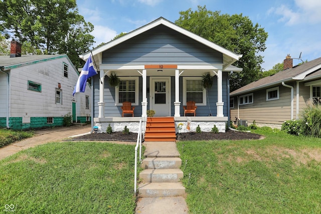 112 S Spencer Ave, Indianapolis, IN 46219 - view of front of home featuring covered porch and a front yard