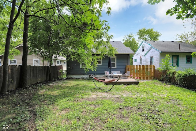 112 S Spencer Ave, Indianapolis, IN 46219 - rear view of house featuring a fenced backyard, a yard, and a wooden deck