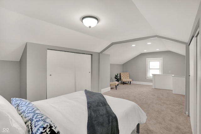112 S Spencer Ave, Indianapolis, IN 46219 - bedroom with a closet, lofted ceiling, baseboards, and light carpet