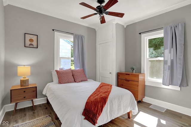 112 S Spencer Ave, Indianapolis, IN 46219 - bedroom featuring baseboards, visible vents, wood finished floors, and ornamental molding