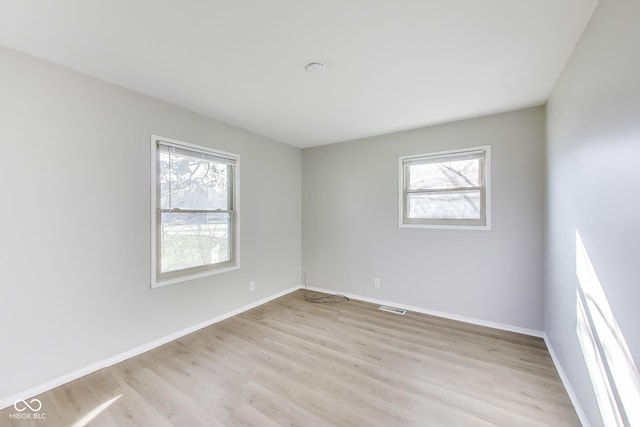 7906 E 21st St, Indianapolis, IN 46219 - spare room with baseboards, visible vents, and light wood-type flooring