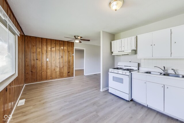 7906 E 21st St, Indianapolis, IN 46219 - kitchen featuring a sink, a ceiling fan, under cabinet range hood, visible vents, and white range with gas stovetop
