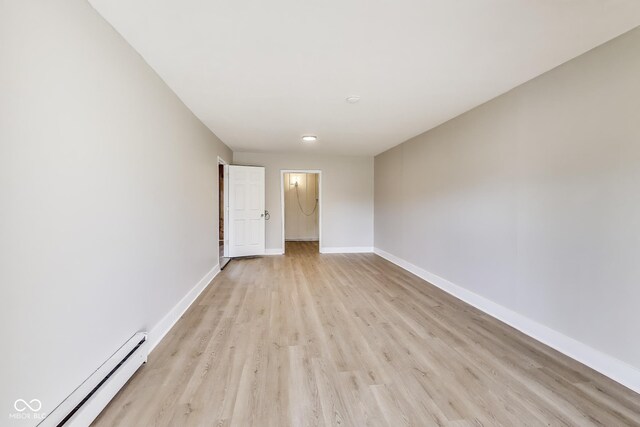 7906 E 21st St, Indianapolis, IN 46219 - spare room with light wood-type flooring, baseboards, and baseboard heating
