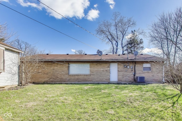 7906 E 21st St, Indianapolis, IN 46219 - back of house with central AC unit, a lawn, and brick siding