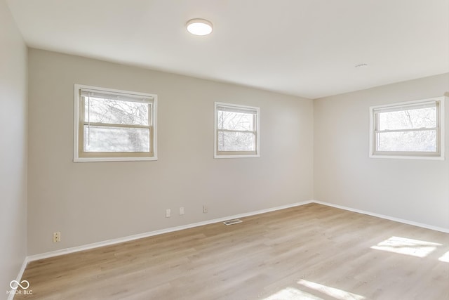 7906 E 21st St, Indianapolis, IN 46219 - unfurnished room featuring visible vents, baseboards, and light wood-type flooring
