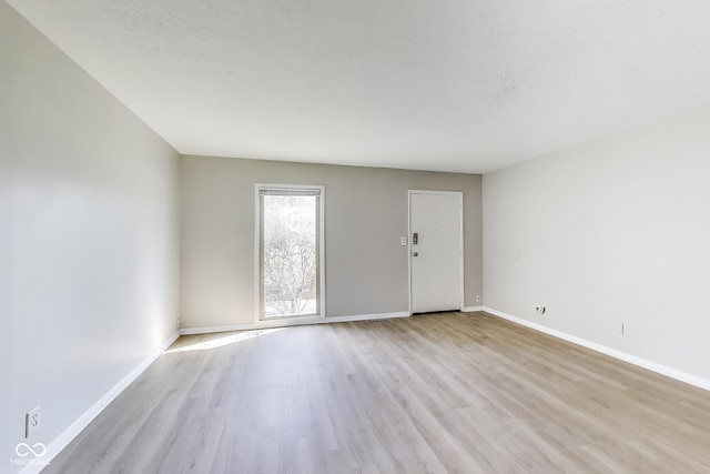 7906 E 21st St, Indianapolis, IN 46219 - interior space with baseboards and light wood-style floors