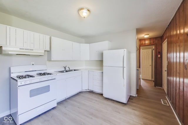 7906 E 21st St, Indianapolis, IN 46219 - kitchen featuring light countertops, a sink, wood walls, under cabinet range hood, and white appliances